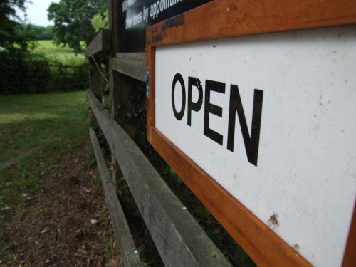 An open sign on a gate at the Windmill
